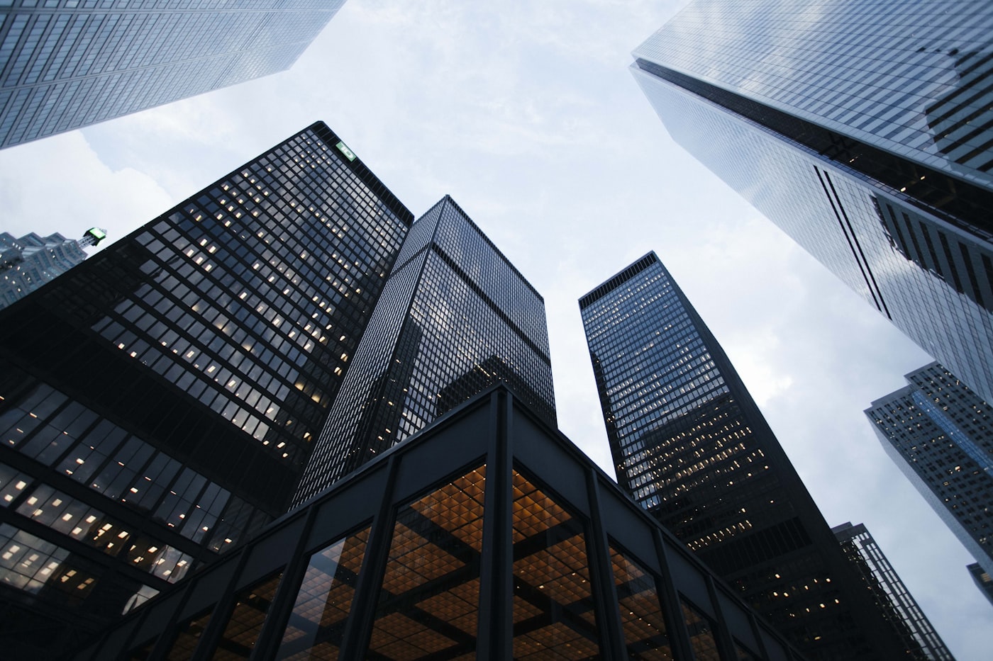 Glass office towers photographed from street level, looking up